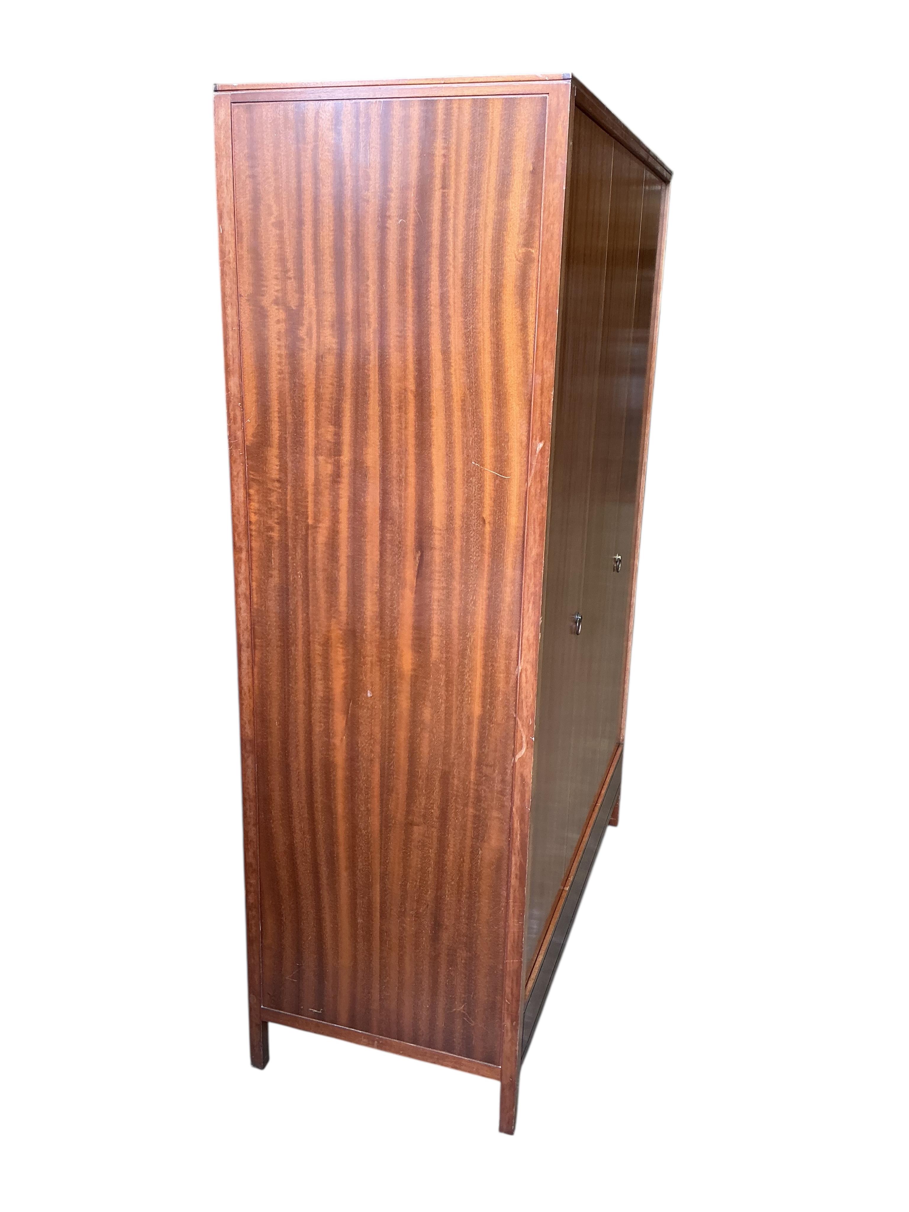 A Loughborough For Heals brass inlaid teak four piece bedroom suite comprising: triple wardrobe, width 120cm, depth 54cm, height 176cm, two chests of drawers and a toilet mirror